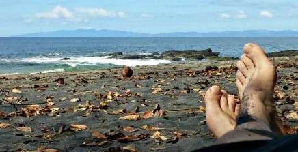 Dave's feet, a coconut, and Playa Ocotal